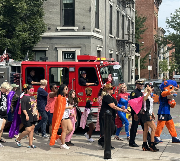 Children and community members at the superhero-themed Back to School Fest booth